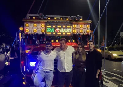 Turistas disfrutando del Tour Alumbrados Medellín frente al bus decorado con luces de Navidad